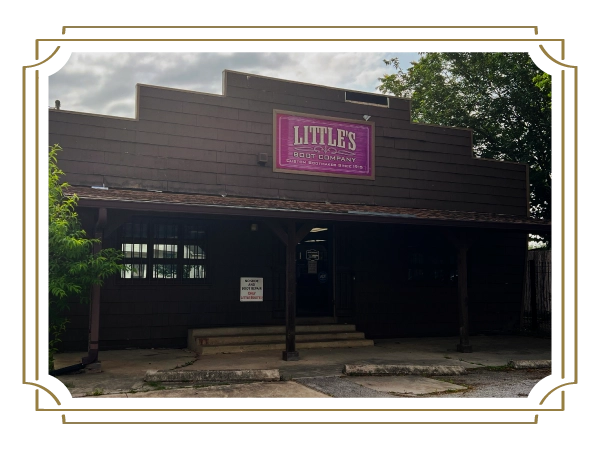 A rustic brown building with a sign that reads "Little's Boot Company" above the entrance.